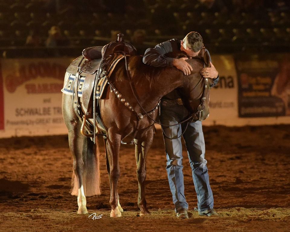 NRCHA Million Dollar Rider Jake Telford in an emotional moment with his 2015 Snaffle Bit Futurity Champion horse, Starlight Kisses (Shady Lil Starlight x Kiss My Shiny Lips x Shining Spark), owned by Holy Cow Performance Horses, LLC.. Primo Morales photo